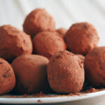 A small white plate piled high with sugar-free chocolate chip truffles.