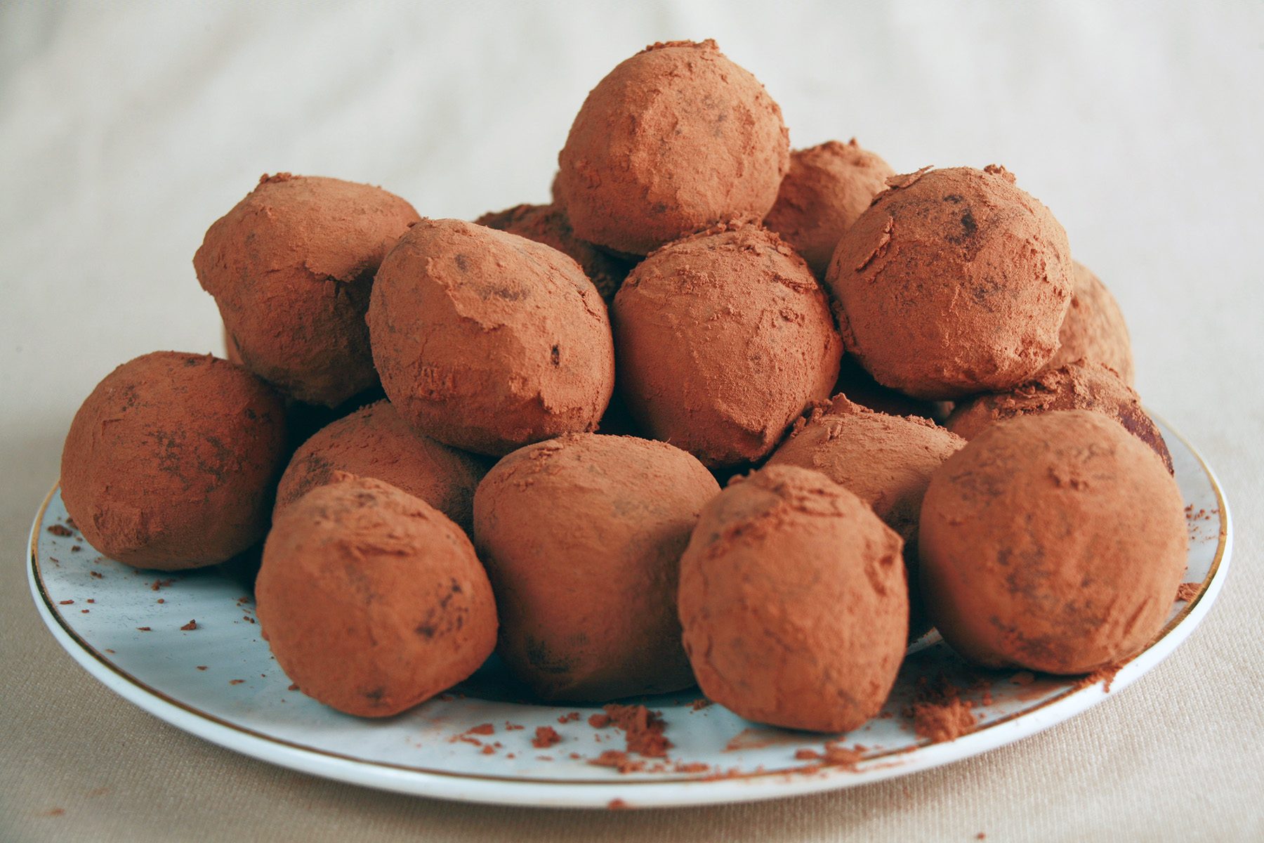 A small white plate piled high with sugar-free chocolate chip truffles.