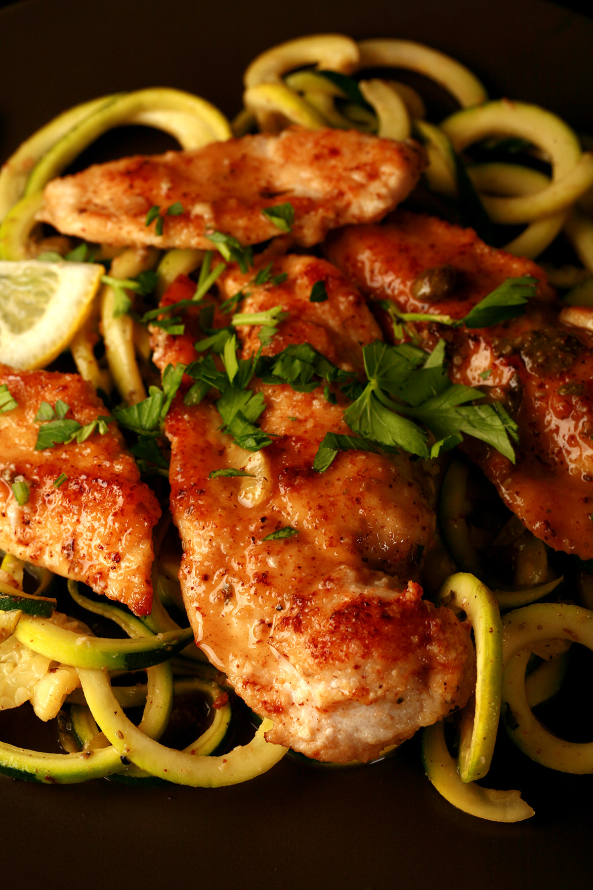 3 pieces of low carb chicken piccata, served on a bed of zoodles - zucchini noodles.