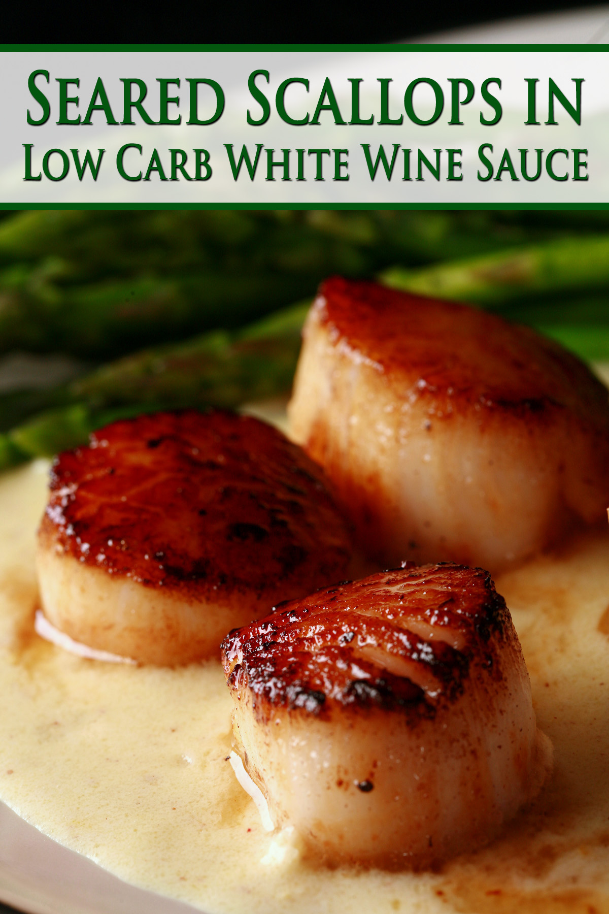 Low carb seared scallops in a Dijon wine sauce. There are asparagus spears on the side.