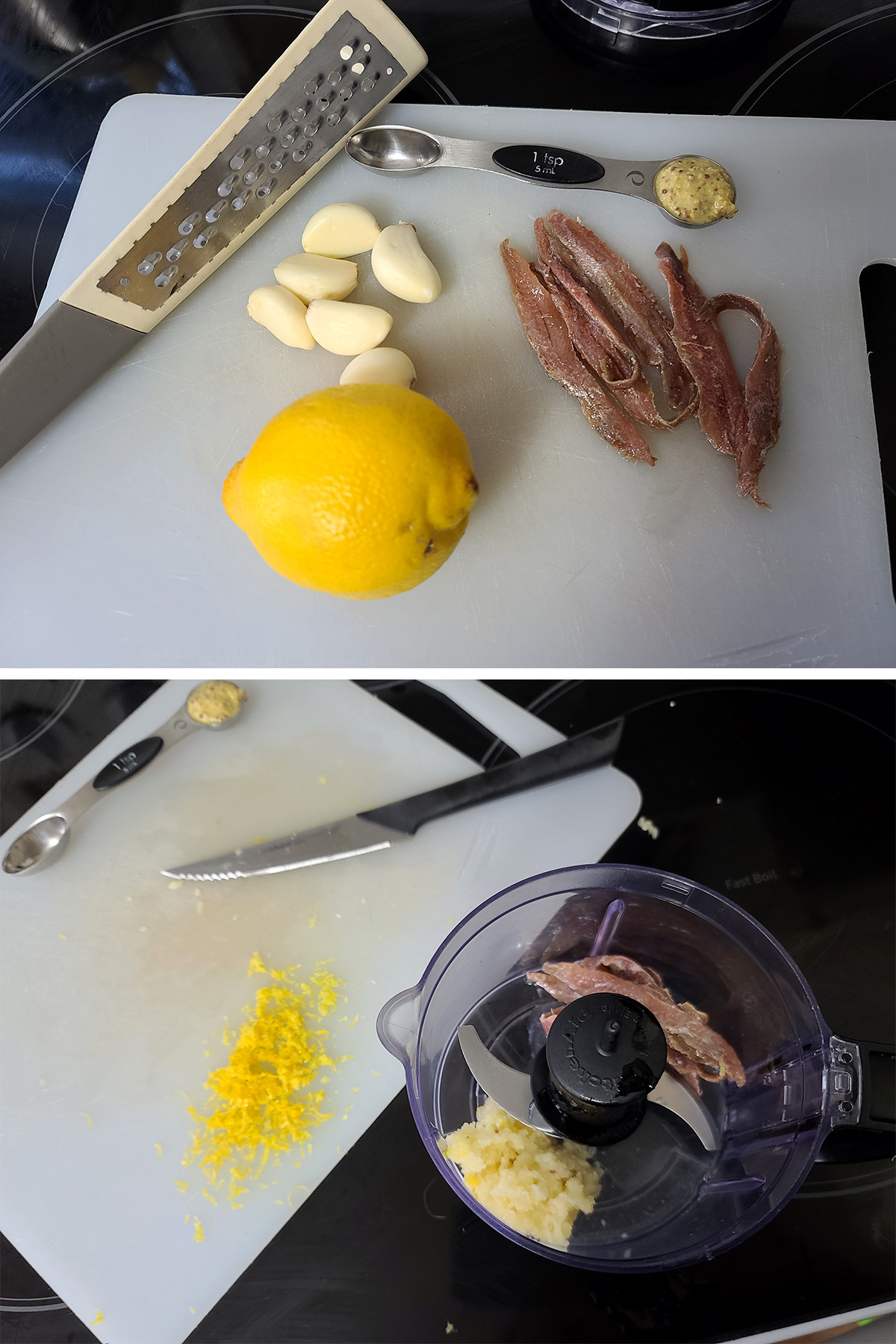 A cutting board with garlic, anchovies, a lemon, and mustard on it.