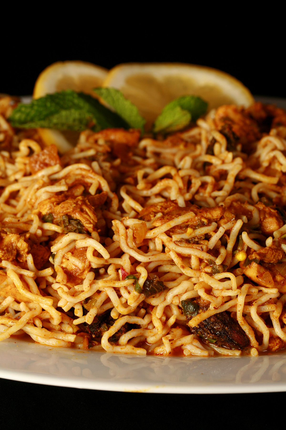 A large oval plate of low carb chicken biryani, using konjac noodles.
