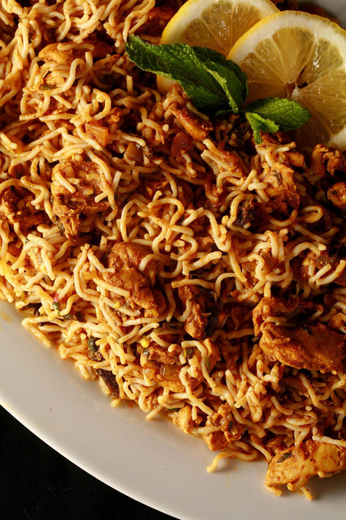 A large oval plate of keto chicken biryani, using konjac noodles.