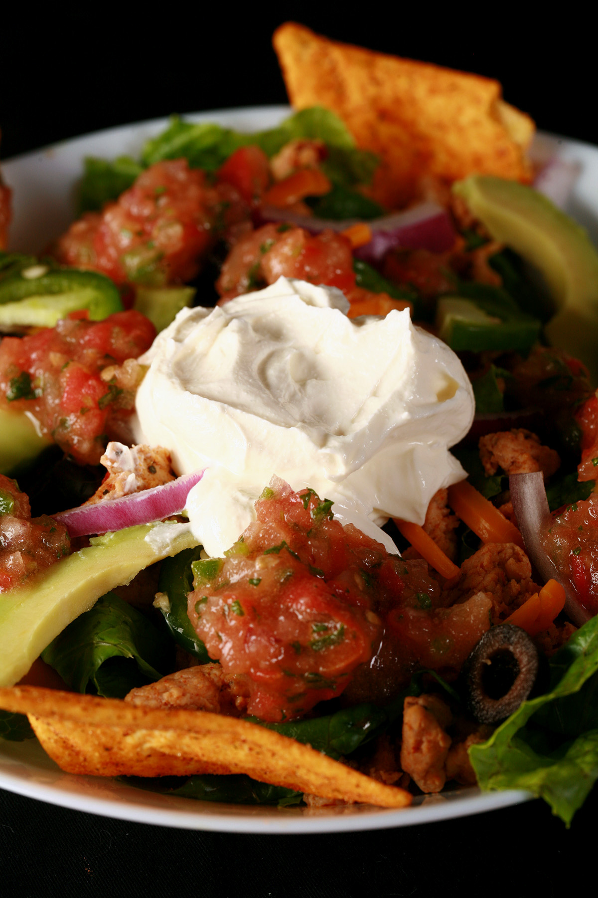 A bowl of low carb taco salad, with protein tortilla chips.
