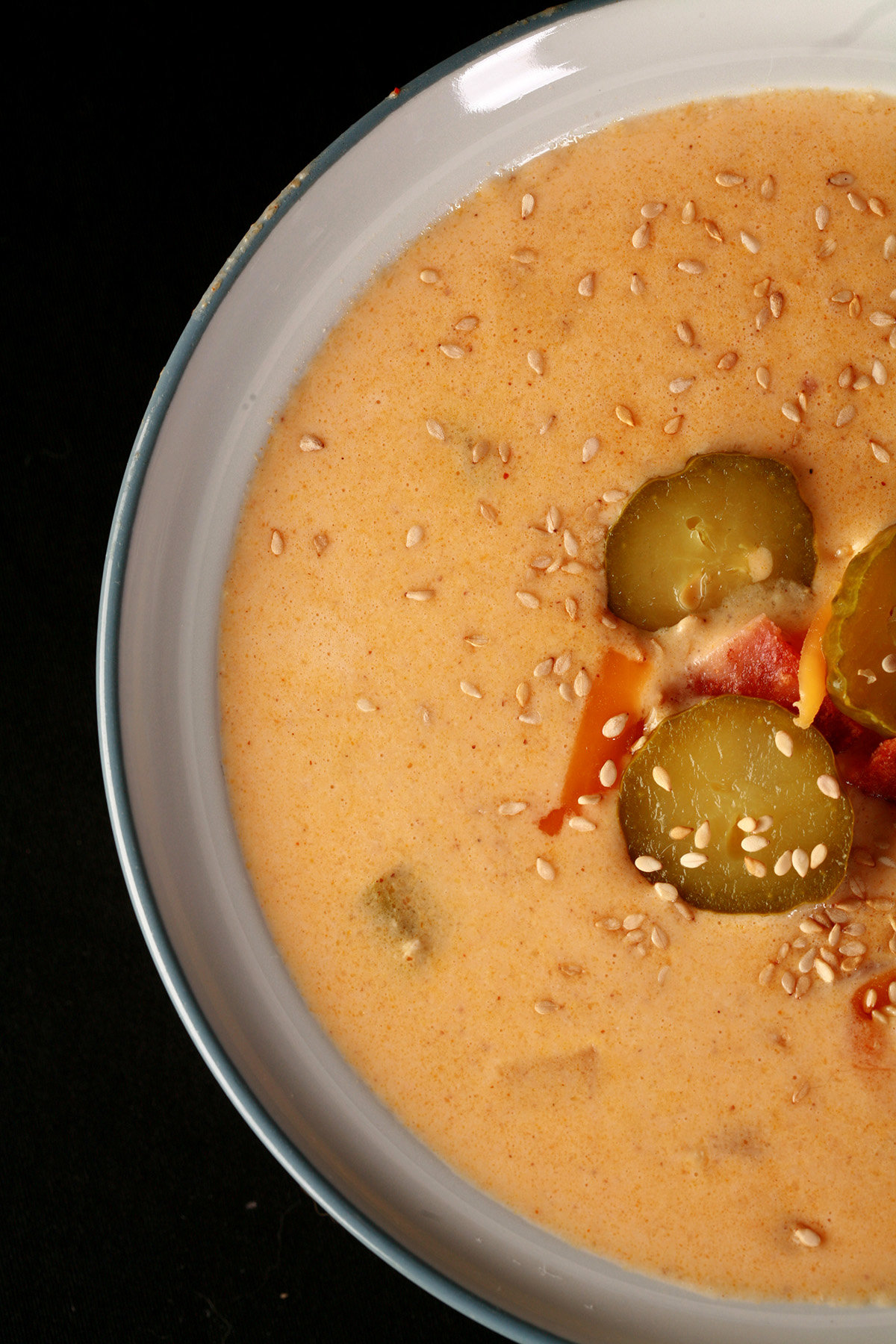 A bowl of low carb bacon cheeseburger soup, made with ground chicken and chicken bacon.