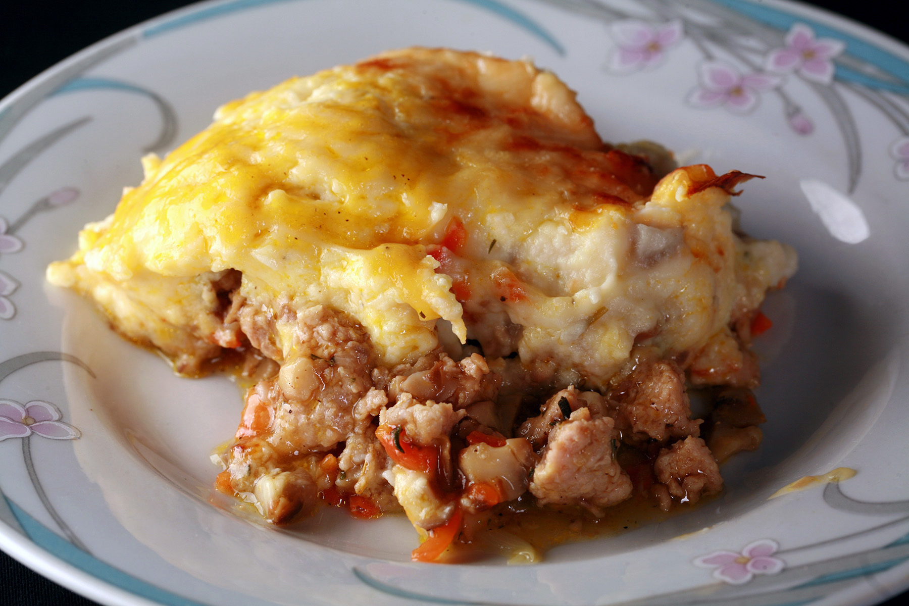 A serving of low carb Shepherd’s Pie on a white plate.
