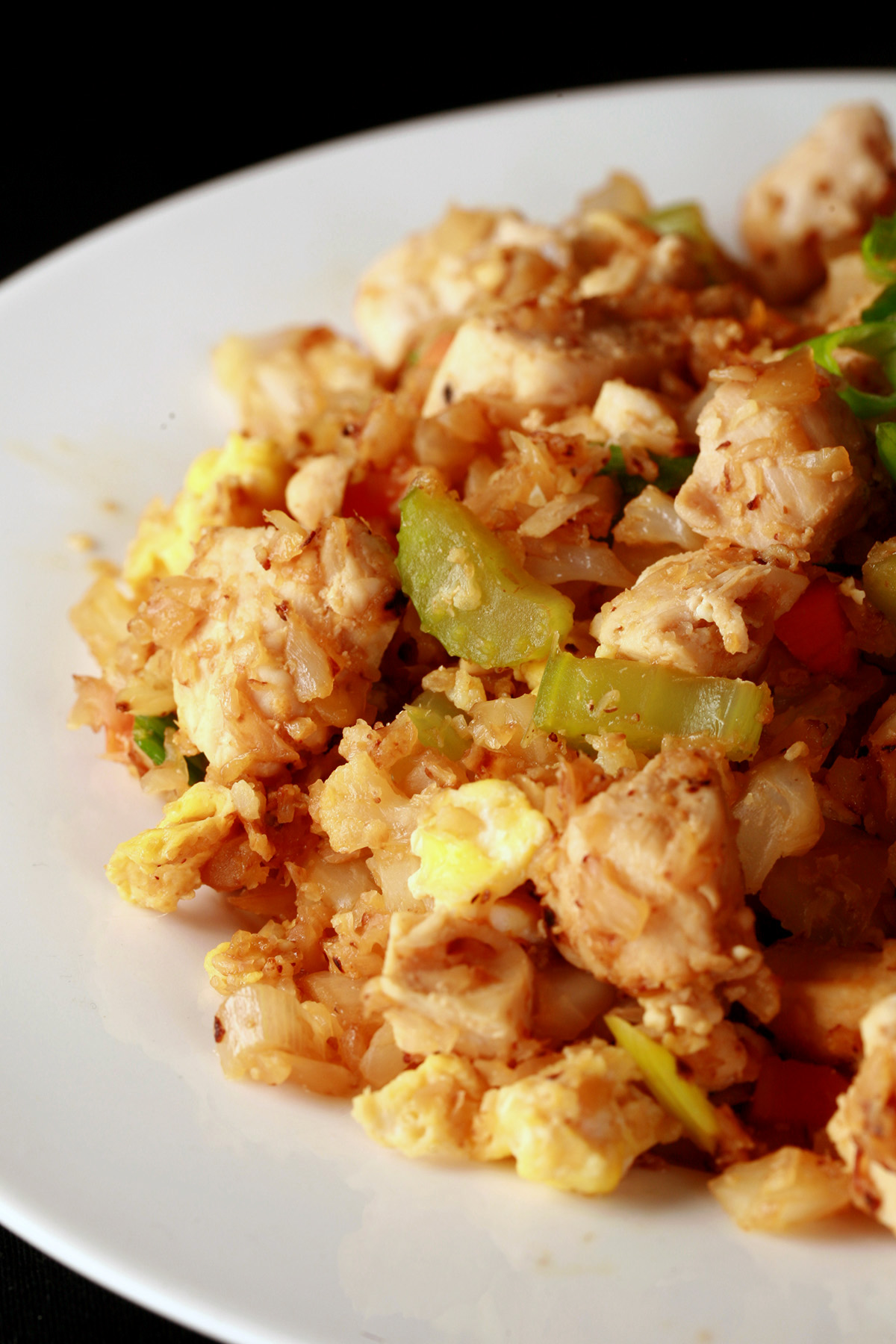 A heaping serving of keto cauliflower fried rice, in a white bowl.