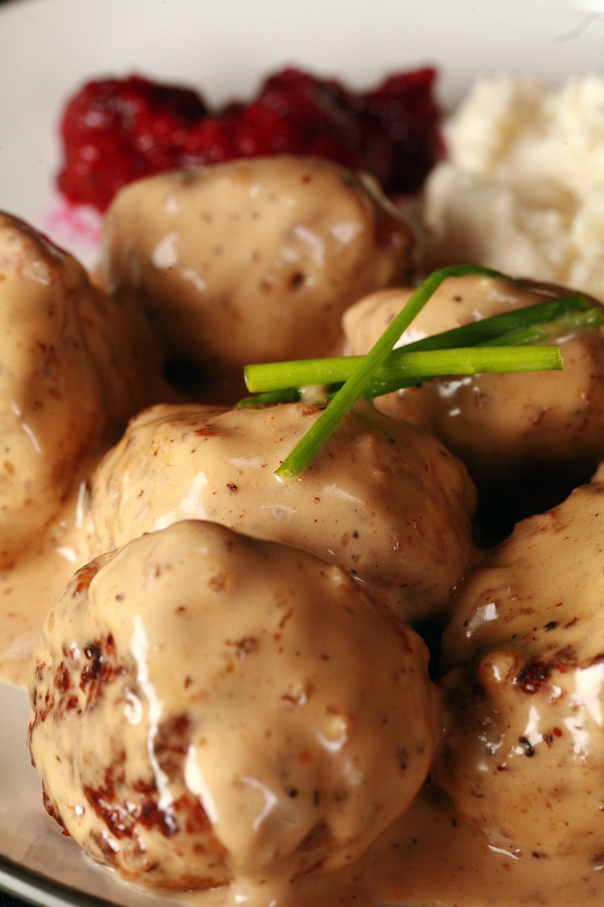 A plate of low carb Swedish meatballs with lingonberry sauce.