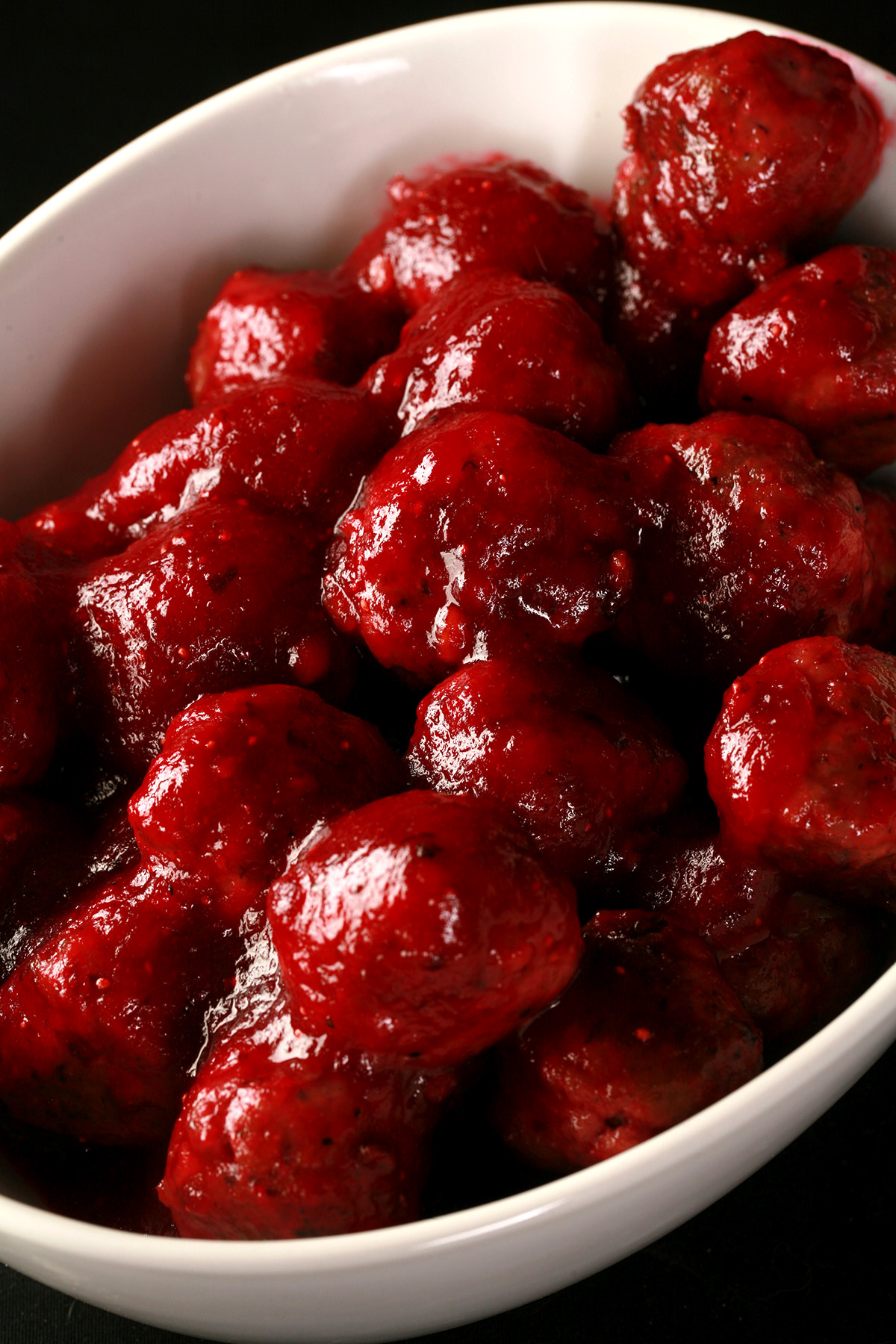 A white bowl filled with low carb turkey meatballs in cranberry glaze.