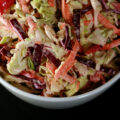 A bowl of colorful low carb coleslaw.