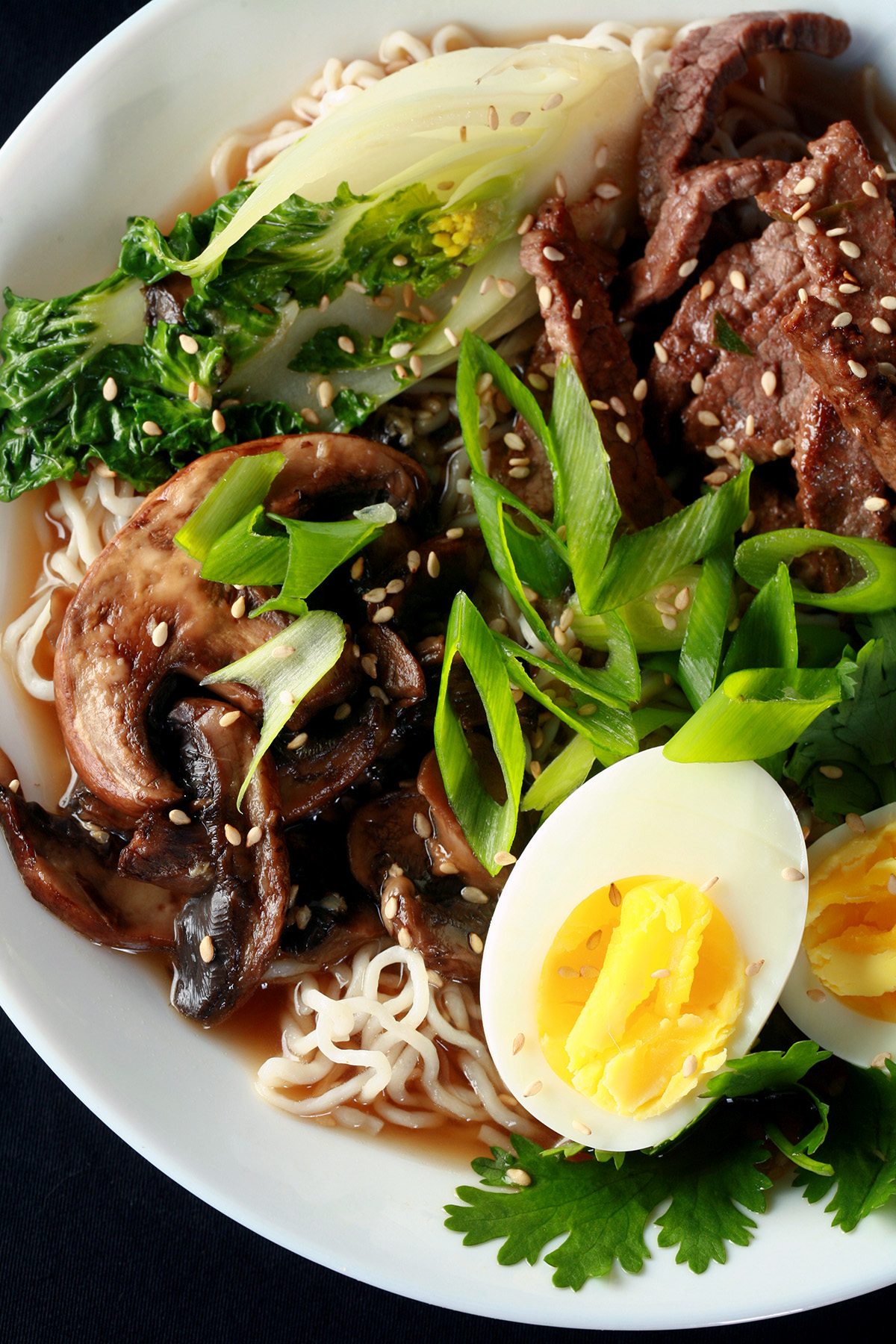 A bowl of low carb ramen noodles, with baby bok choy, eggs, and more.