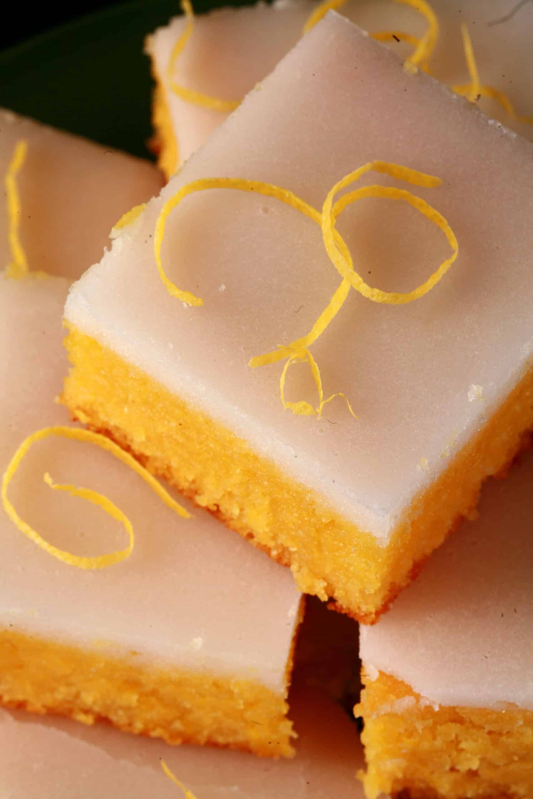 A plate of low carb lemon bars topped with a white glaze.