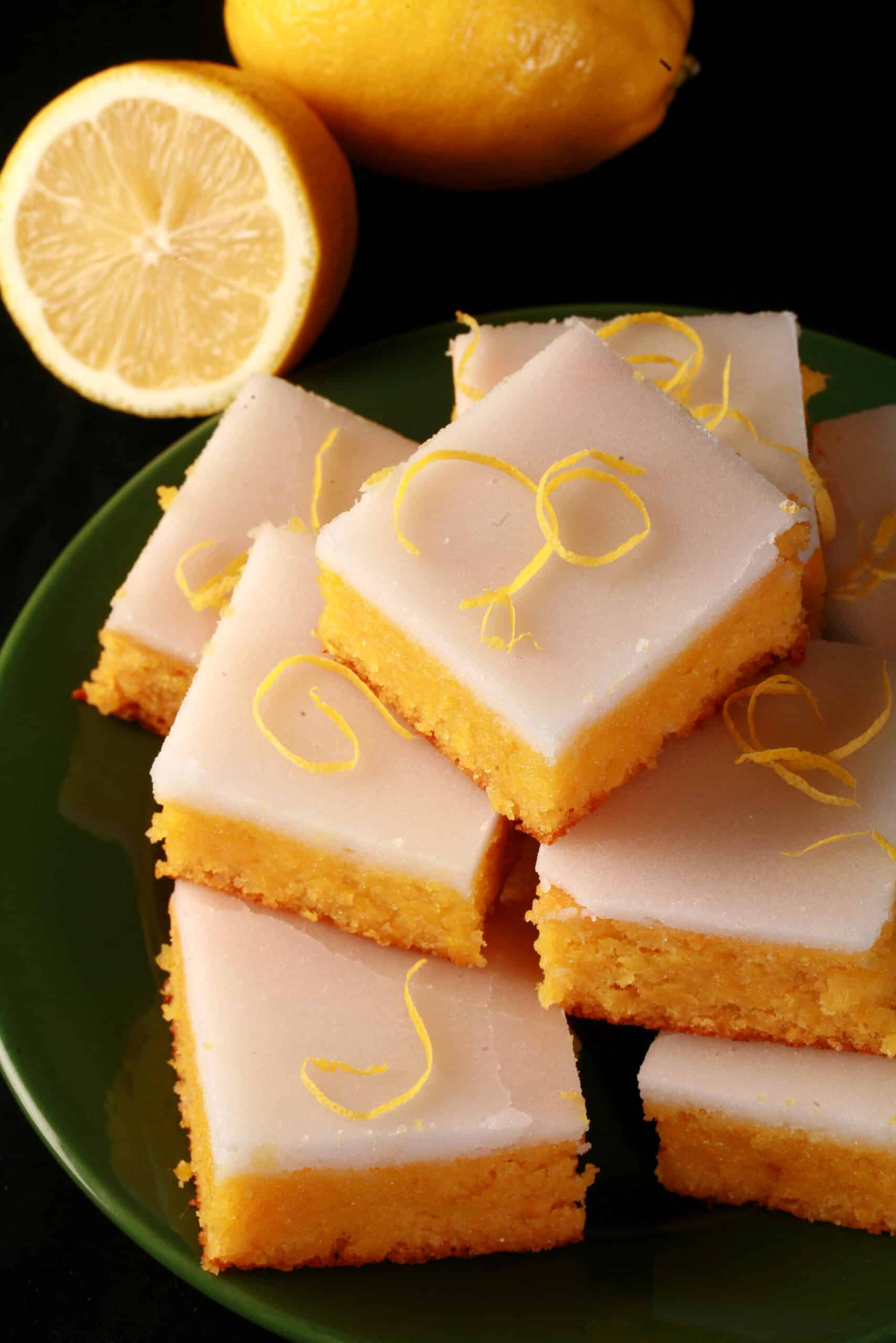 A plate of keto lemon bars topped with a white glaze.