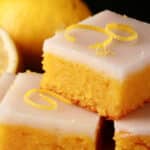 A plate of low carb lemon bars topped with a white glaze.