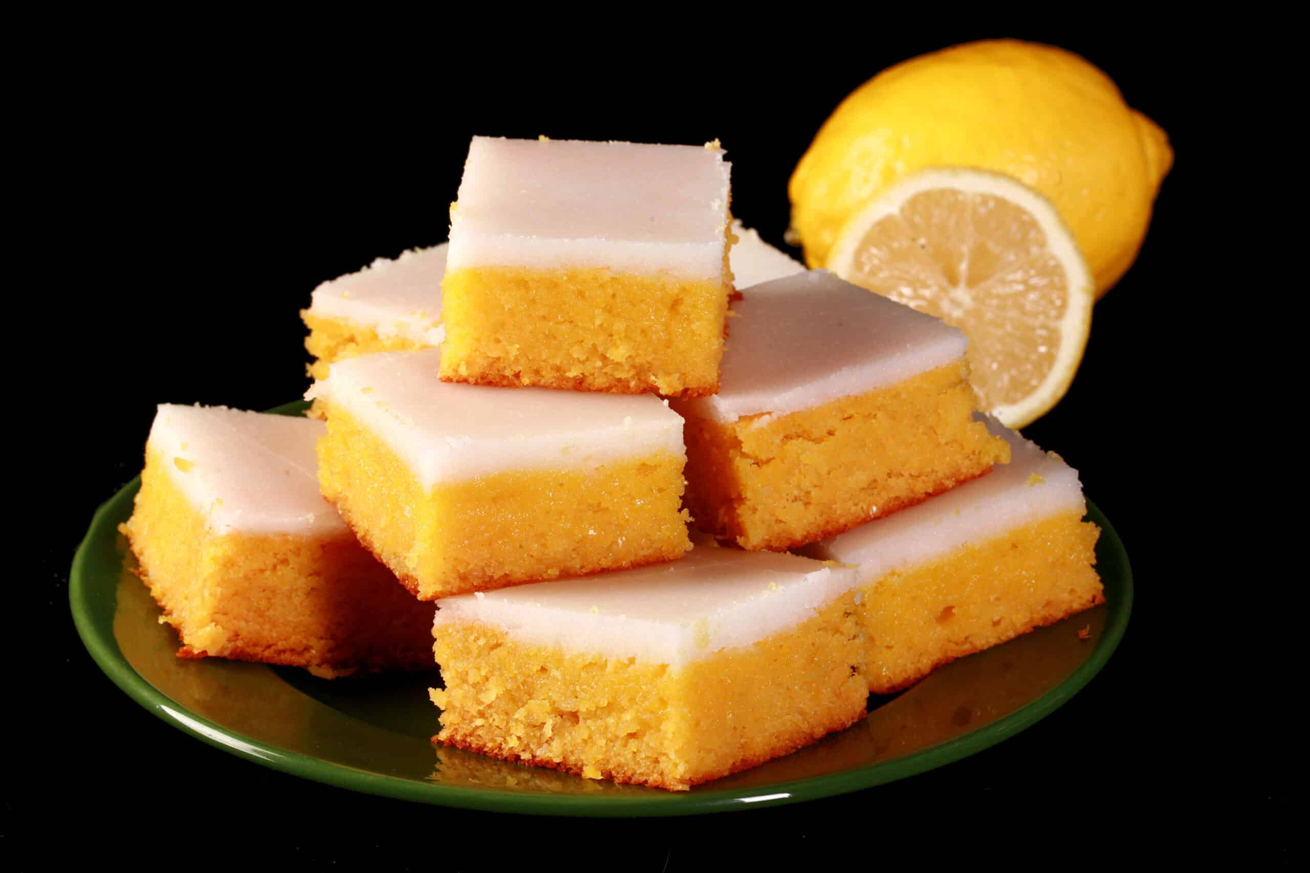 A plate of keto lemon bars topped with a white glaze.