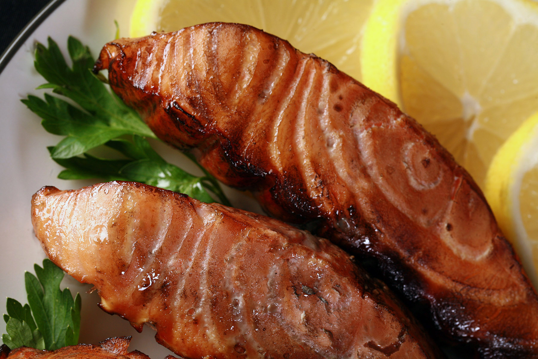 Several servings of hot smoked salmon on a plate.