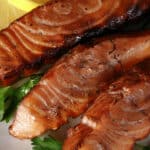 Several servings of hot smoked salmon on a plate.
