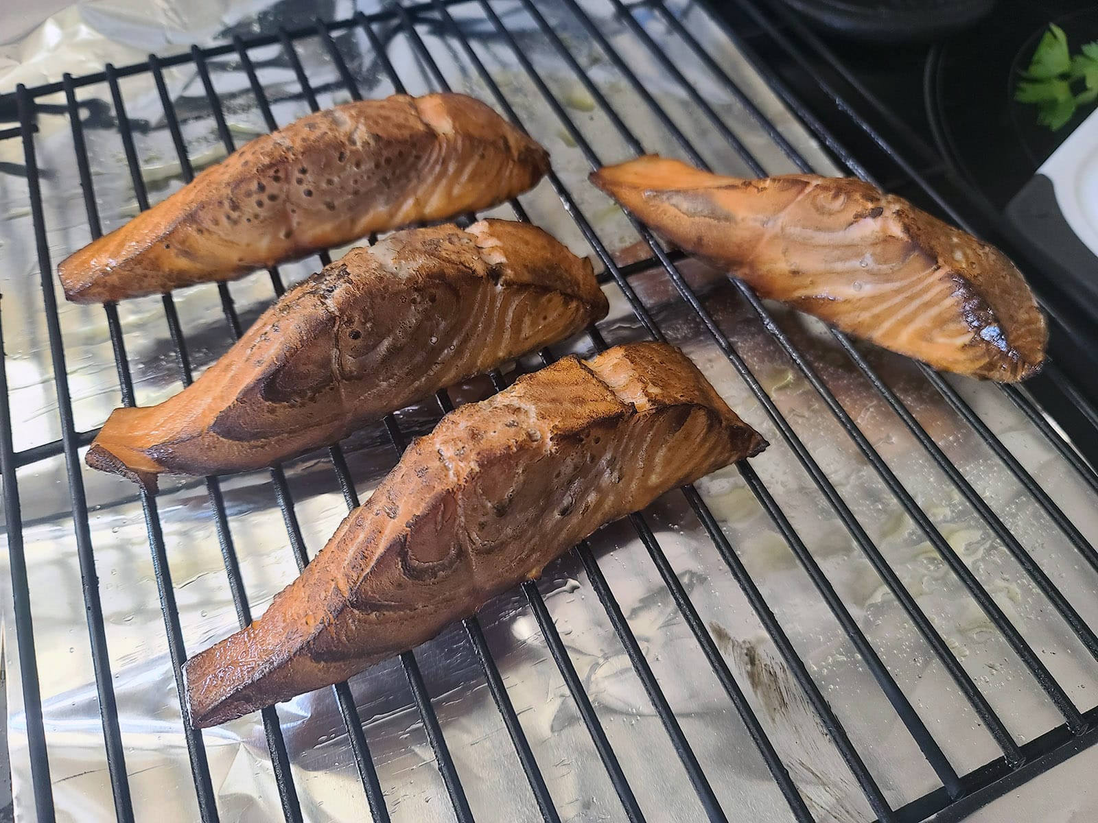 4 portions of hot smoked salmon on a rack.