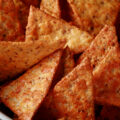 A white bowl filled with keto tortilla chips.