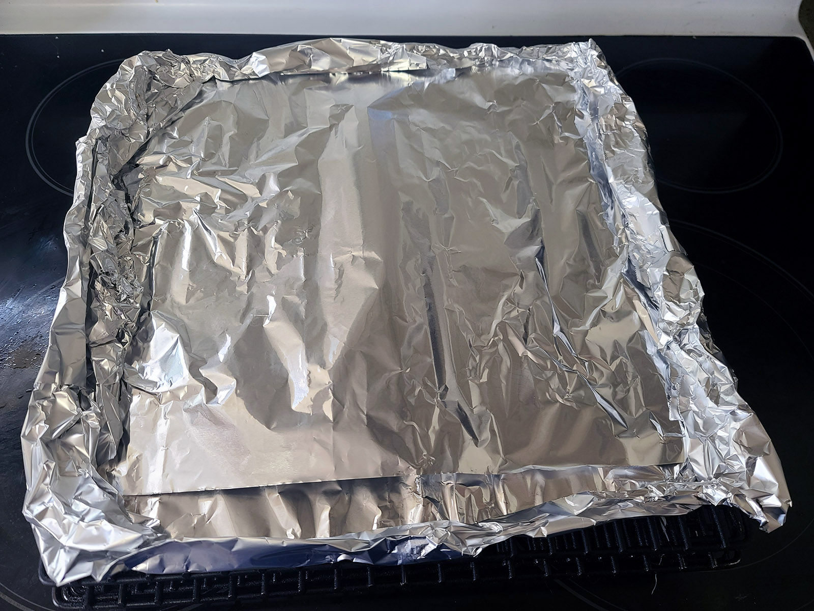 The smoking rack covered in foil.