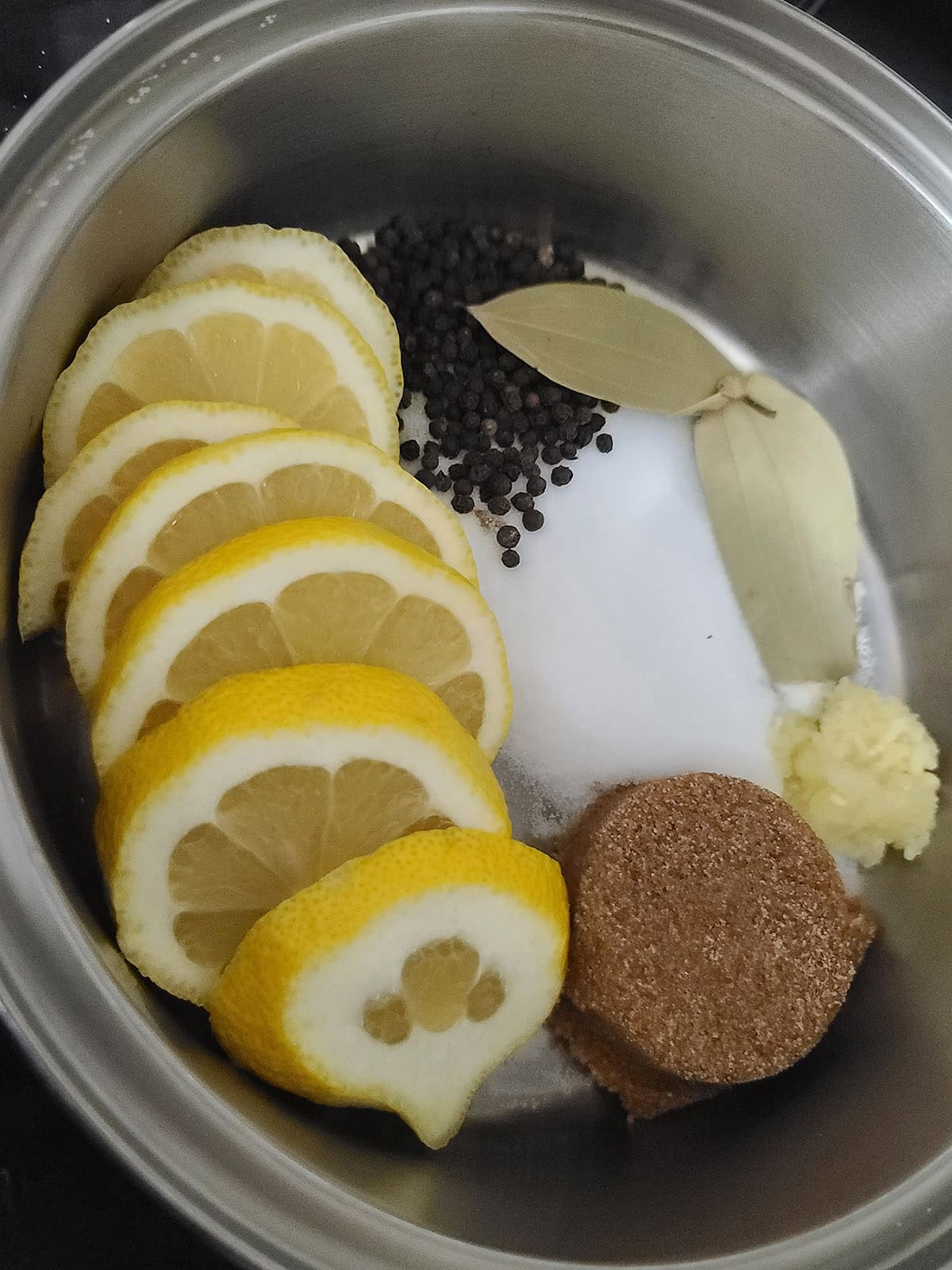 Lemon, brown sugar substitute, salt, garlic, and spices in a pot.