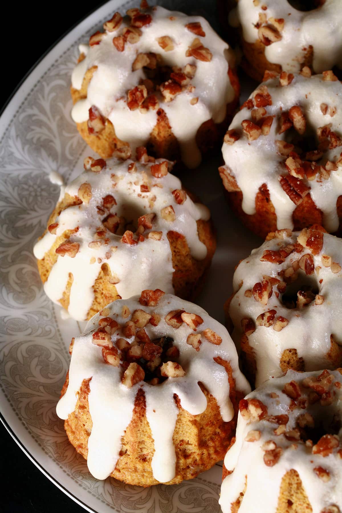 Several low carb carrot cake mini bundt cakes on a plate.