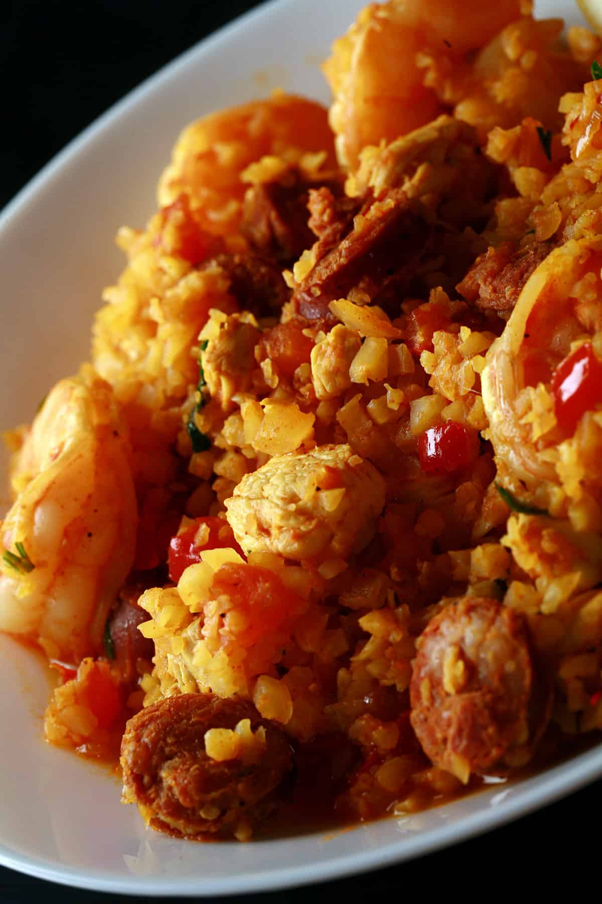 A bowl of keto paella, with shrimp, chicken, and chorizo visible.