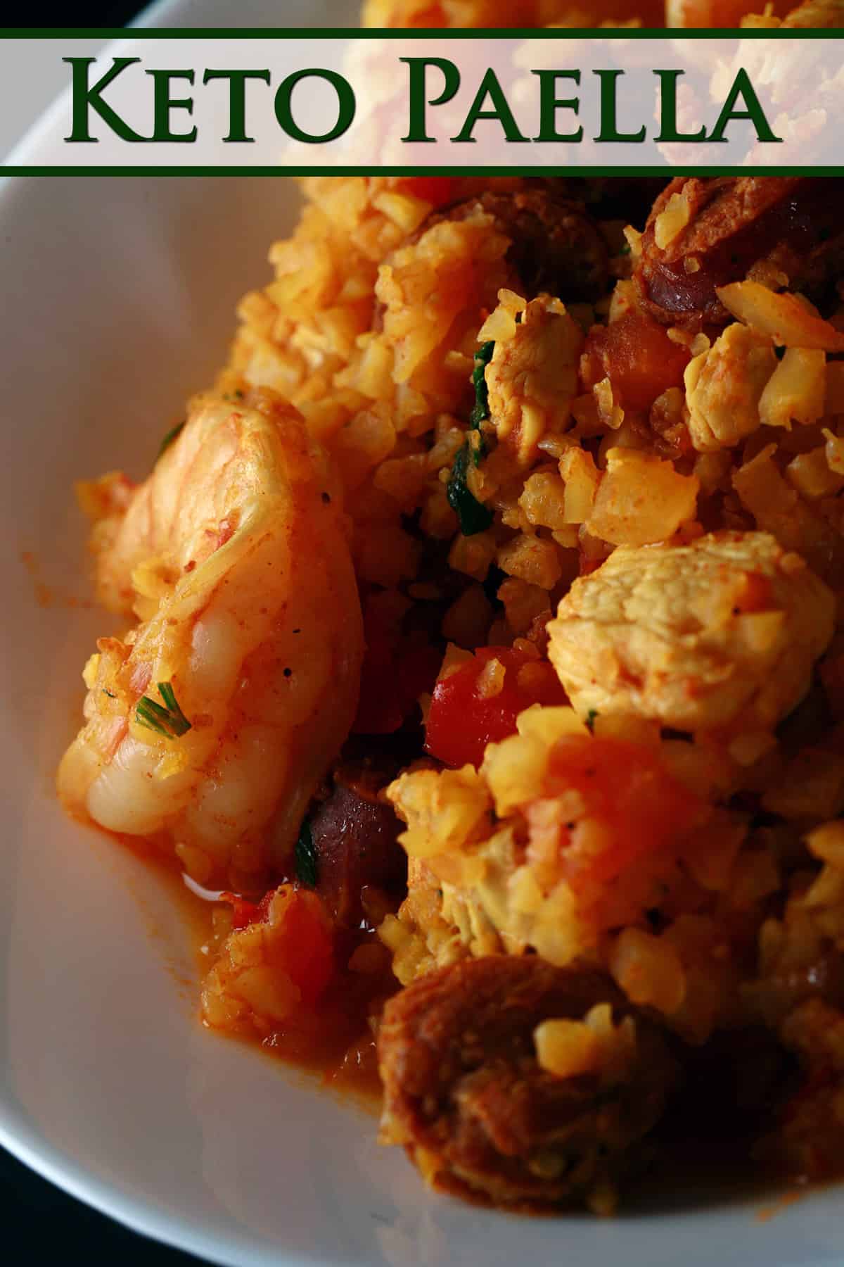 A bowl of cauliflower paella, with shrimp, chicken, and chorizo visible.