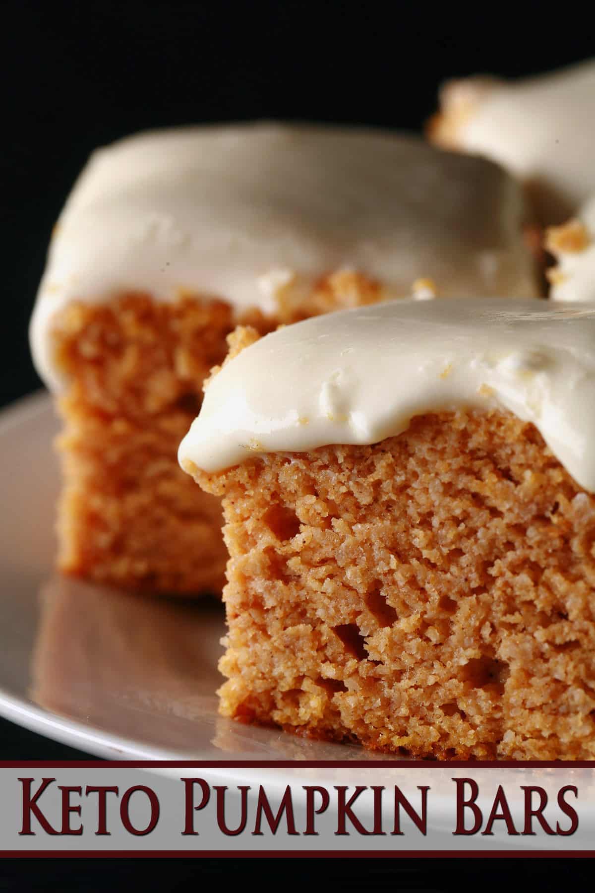 A plate of low carb pumpkin cake bars with cream cheese icing.