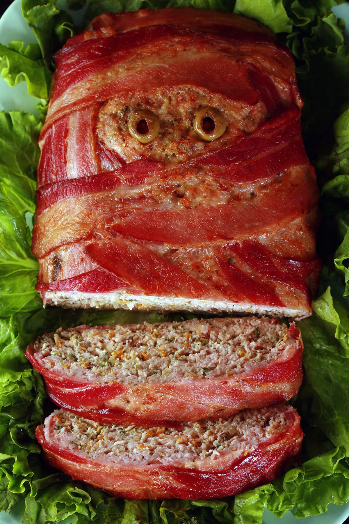 A halloween meatloaf, wrapped in bacon to look like a mummy. It has olive eyes.
