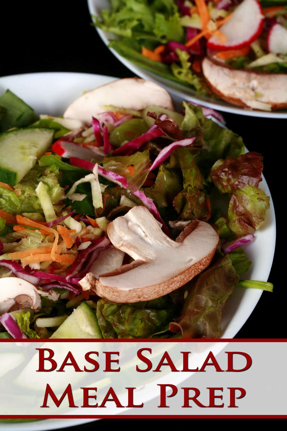 A bowl of base salad, with lettuce, mushrooms, radishes, cucumbers, etc visible.