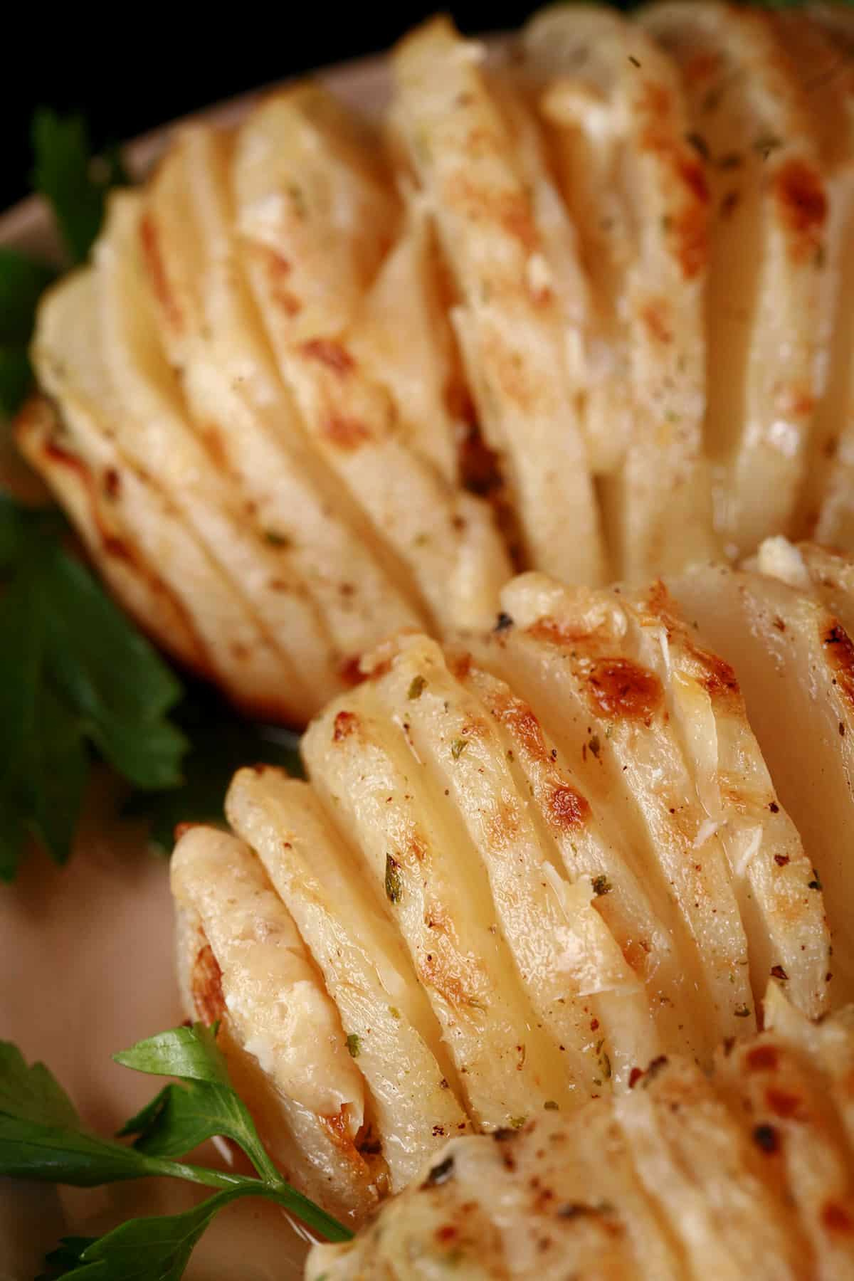 3 hasselback turnips on a plate.