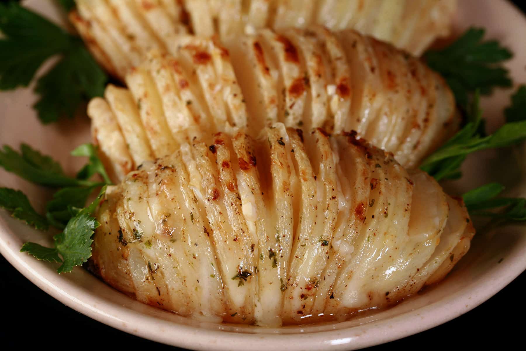 3 hasselback style keto turnips on a plate.