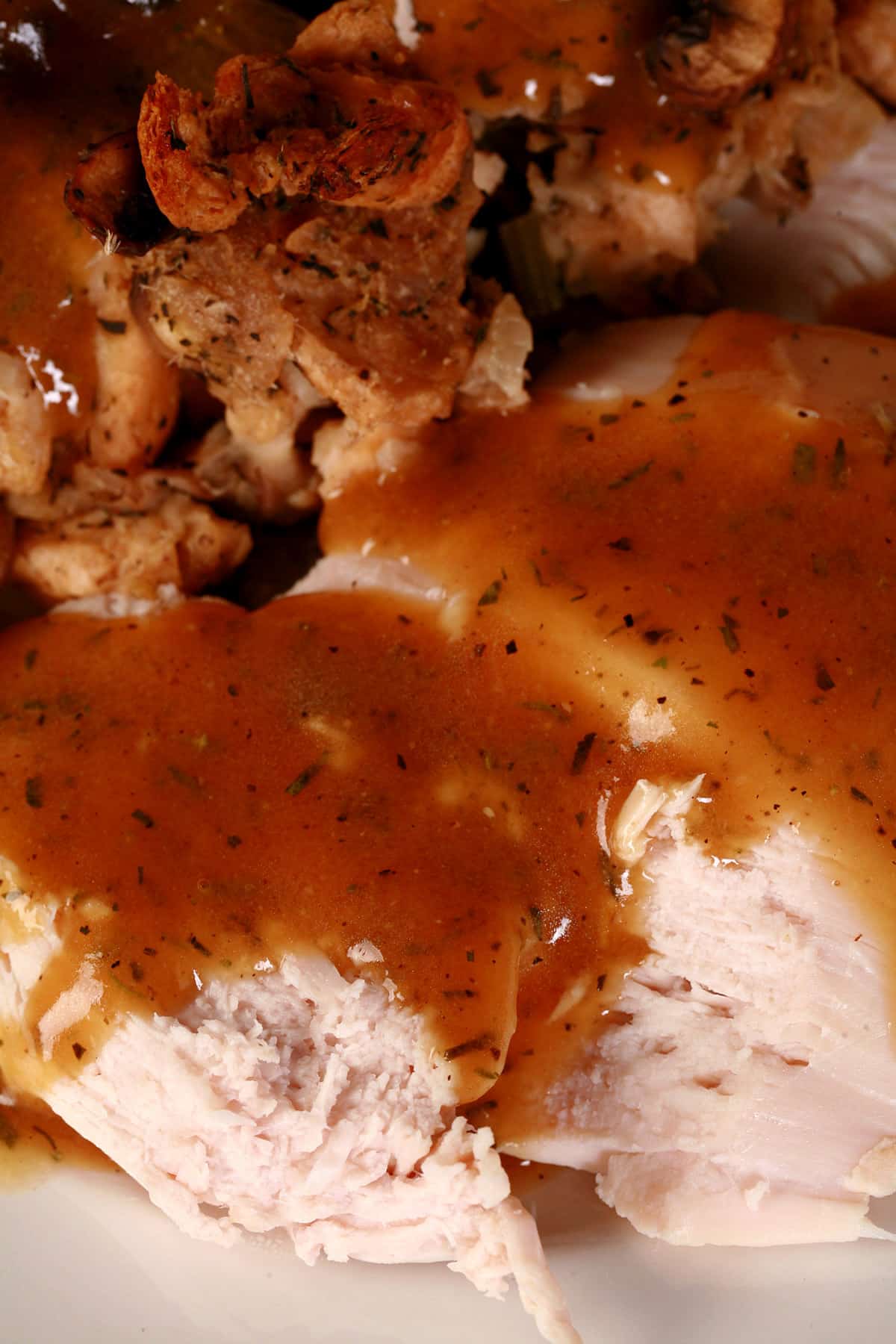 A plate of keto stuffing and turkey, covered in keto turkey gravy.