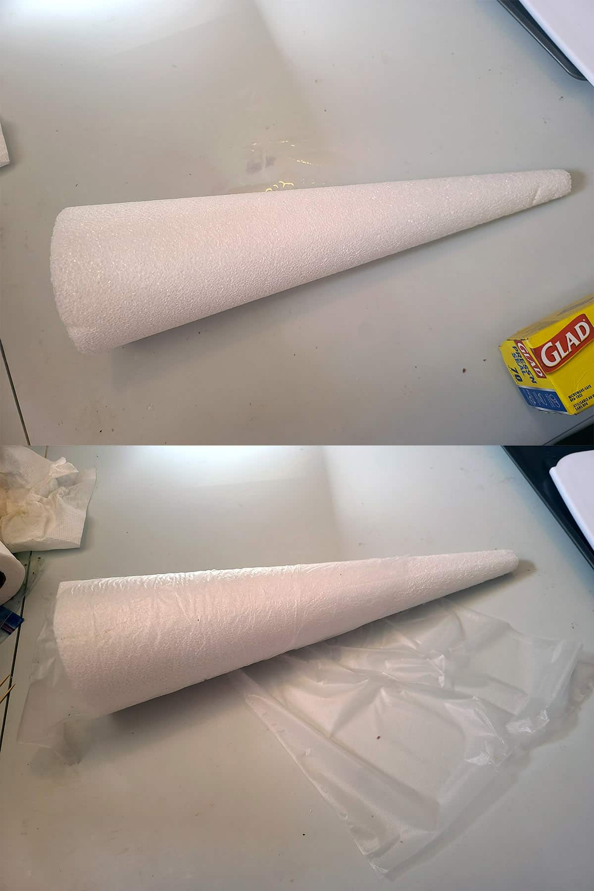 A styrofoam cone being wrapped with cling wrap.