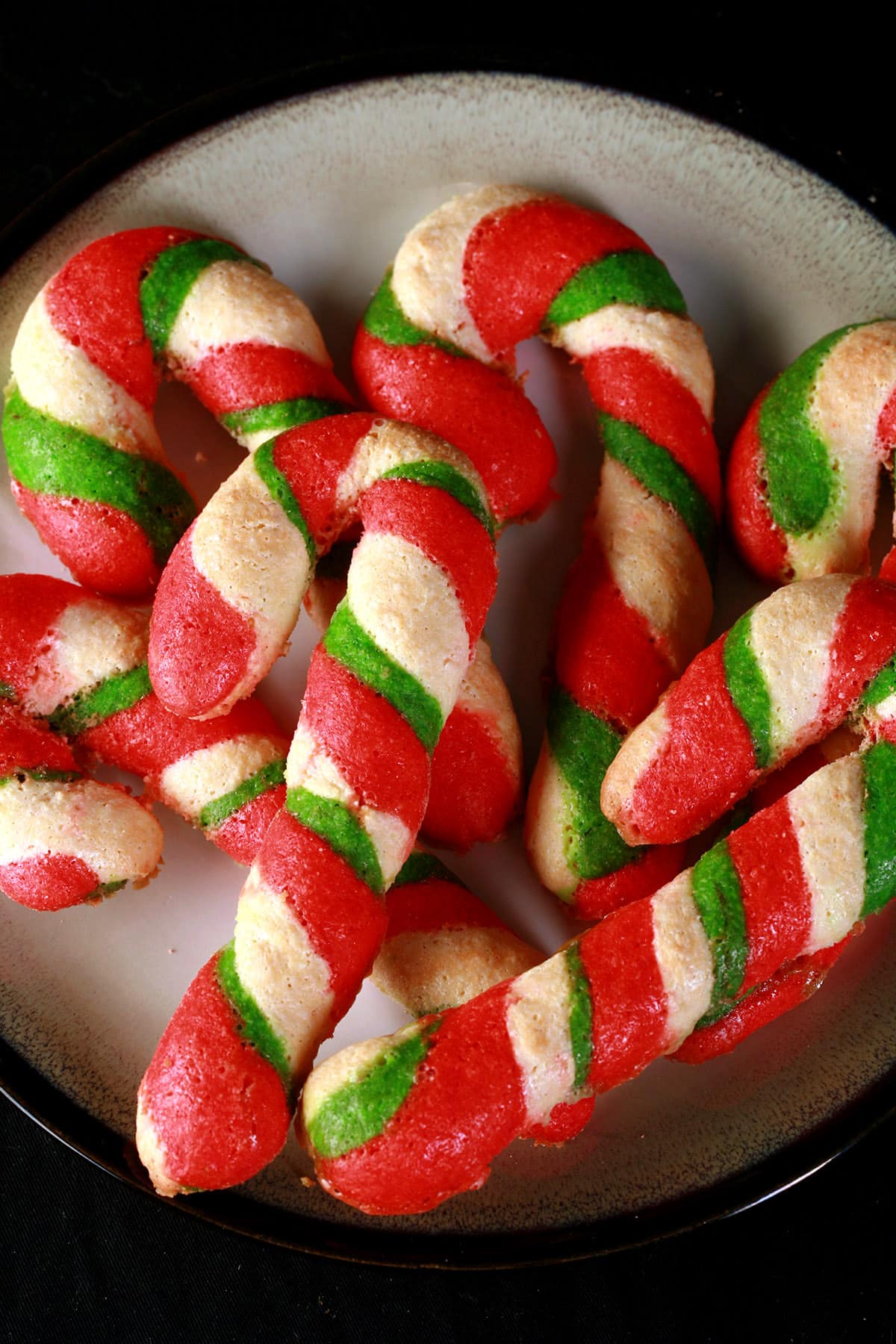 A plate of keto candy cane shaped cookies.