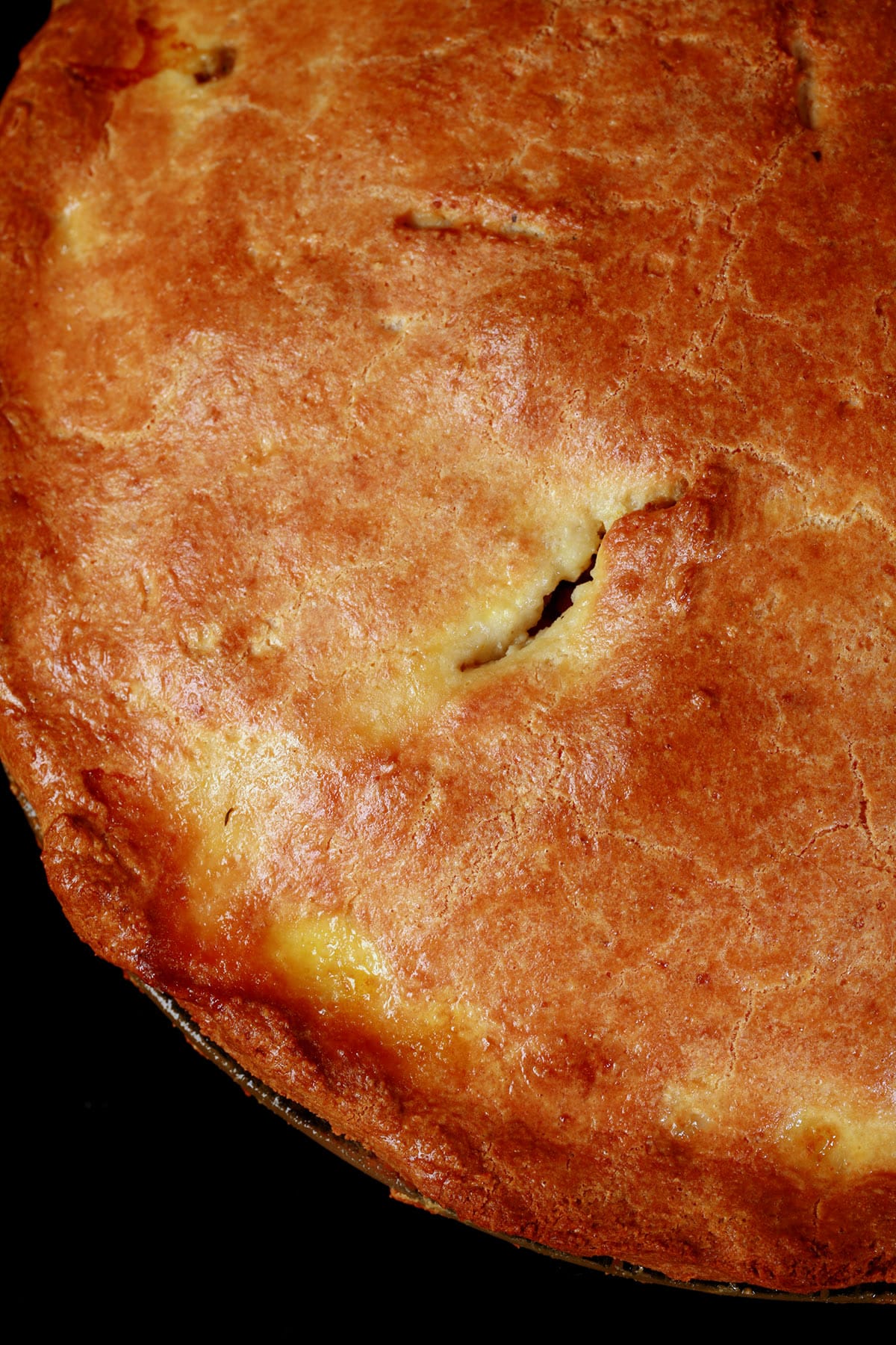 A close up view of an un cut keto tourtiere meat pie.