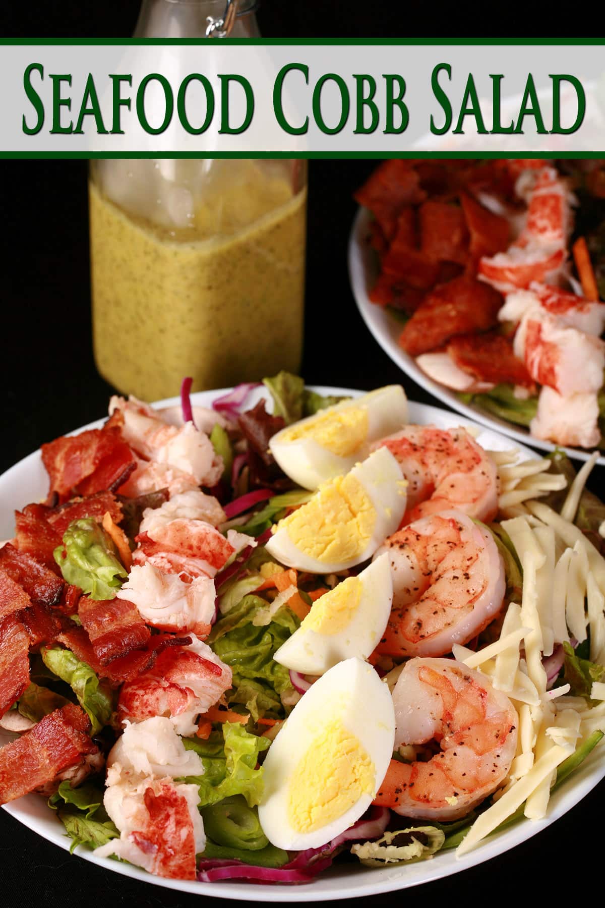 Two seafood cobb salads with a bottle of lemon dill vinaigrette.