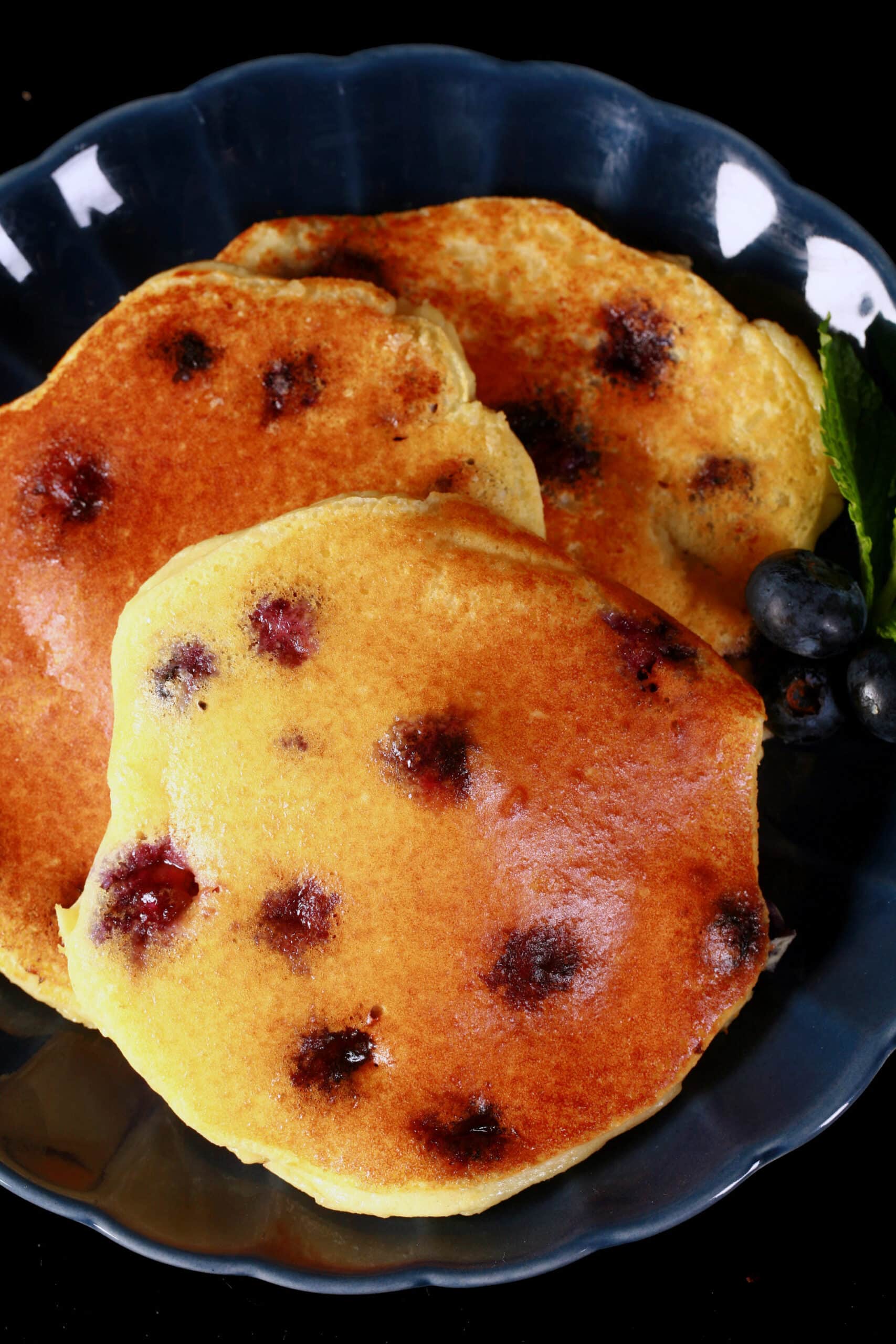 A plate of low carb blueberry protein pancakes.