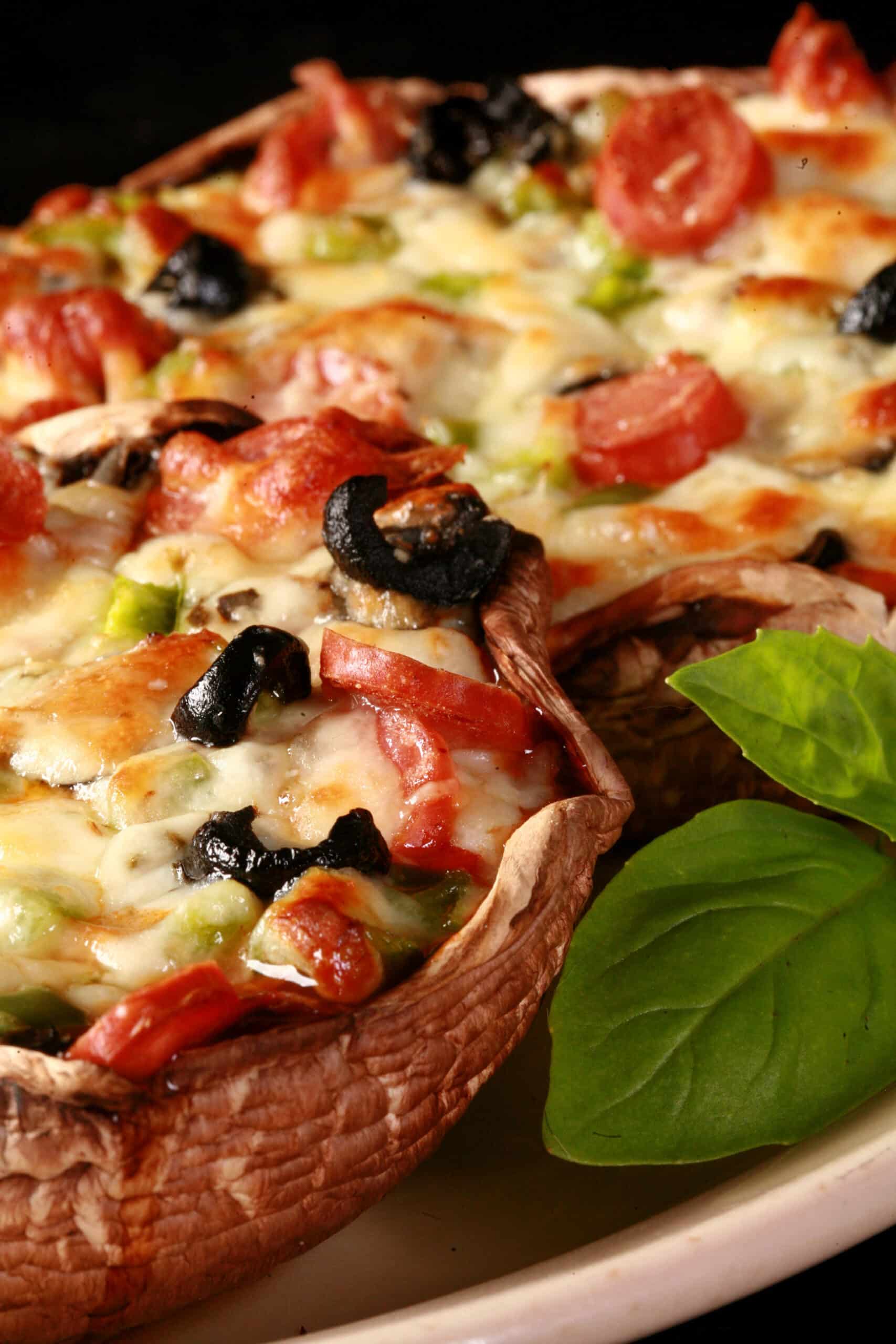 2 portabella mushroom pizzas on a plate.