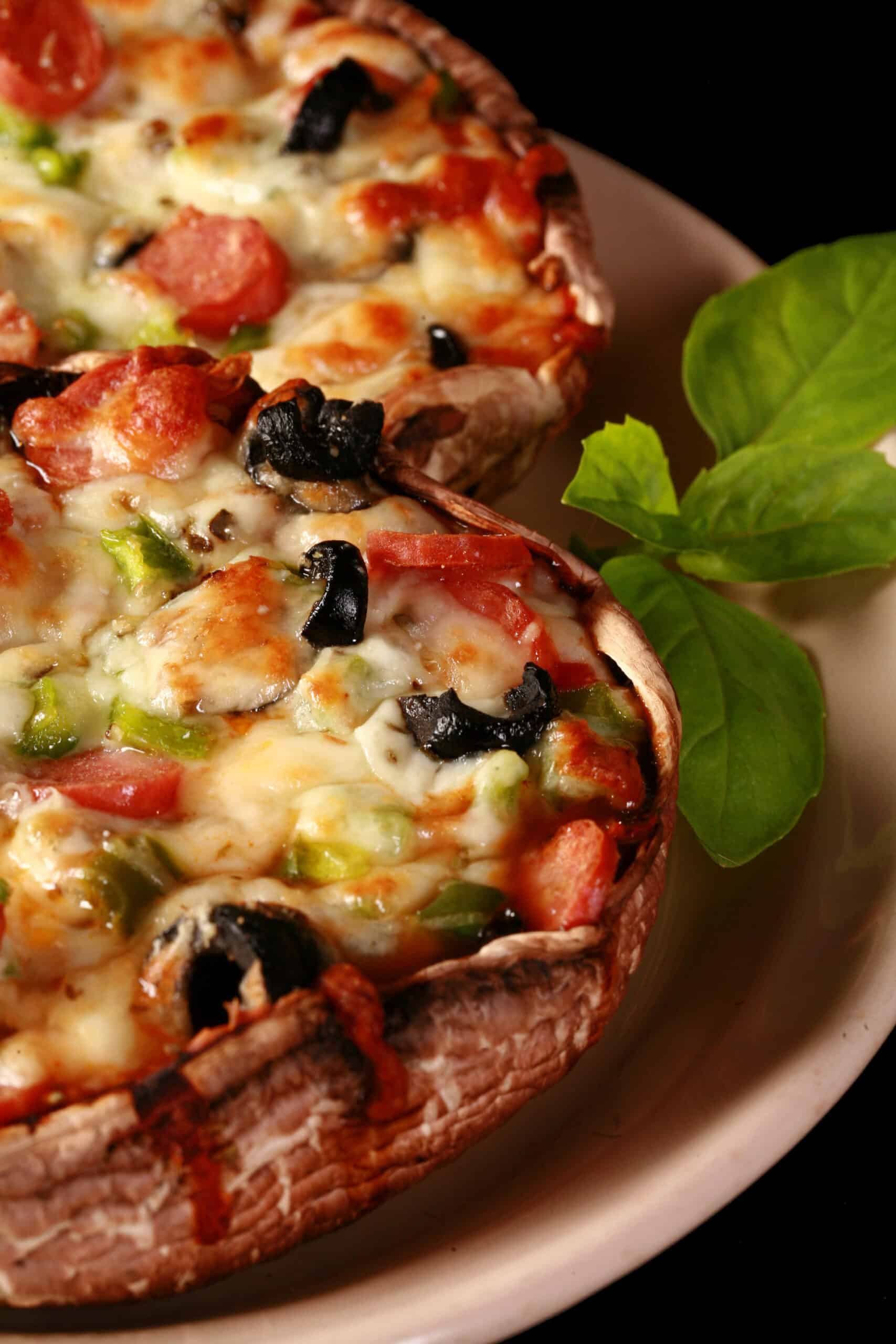 2 low carb portabella mushroom pizzas on a plate.