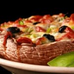 A close up view of a keto portobello mushroom pizza.