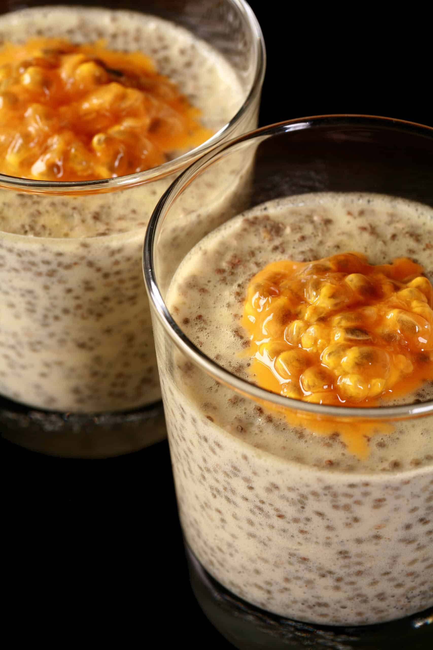 2 glasses of low carb passion fruit protein pudding, topped with fresh passionfruit.