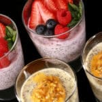 4 glasses of keto protein pudding with chia seeds. 2 are yellow and topped with passionfruit, the other two are pink and topped with berries.