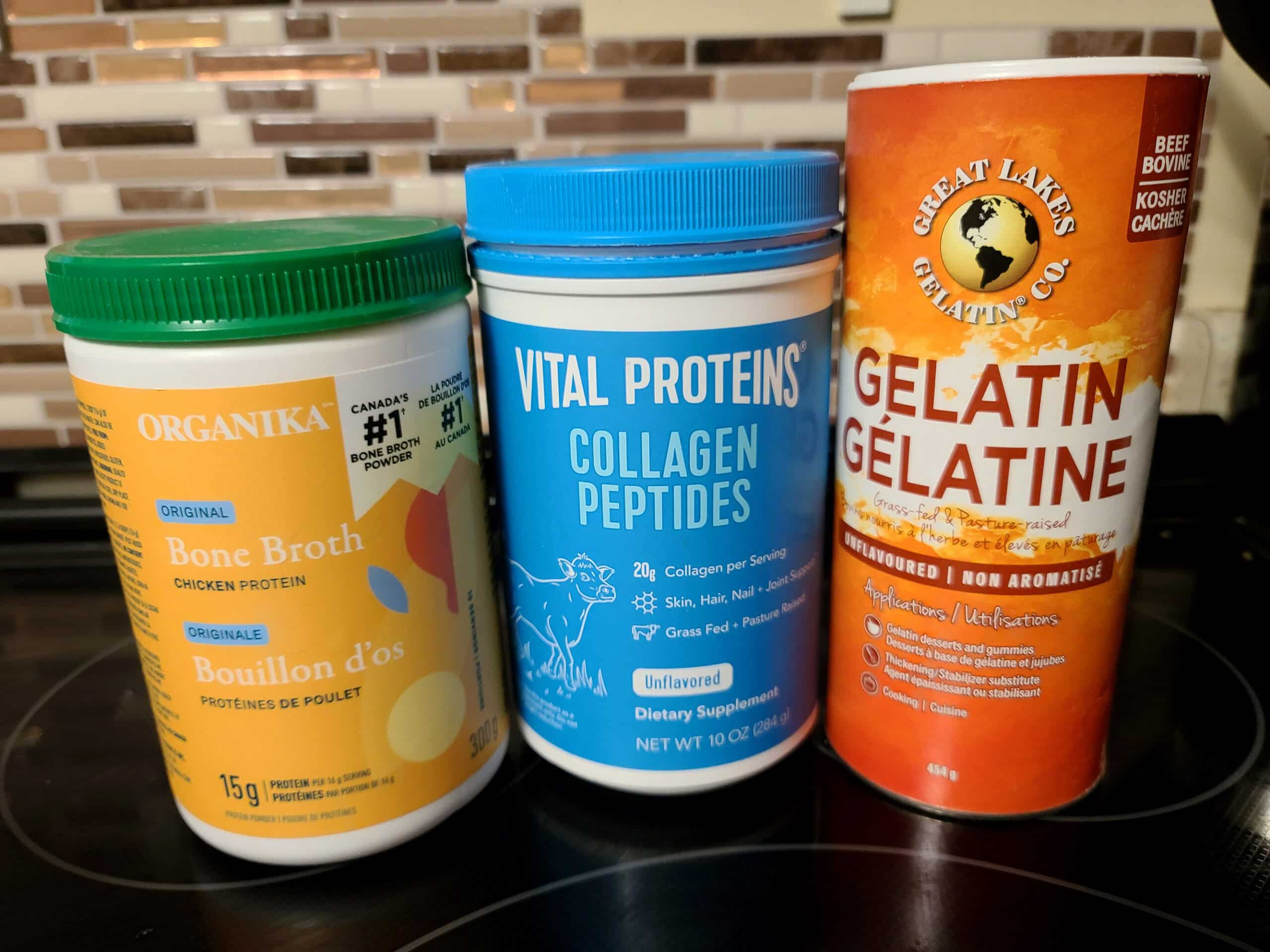 3 canisters on a stove top: powdered bone broth, collagen peptides, and gelatin.