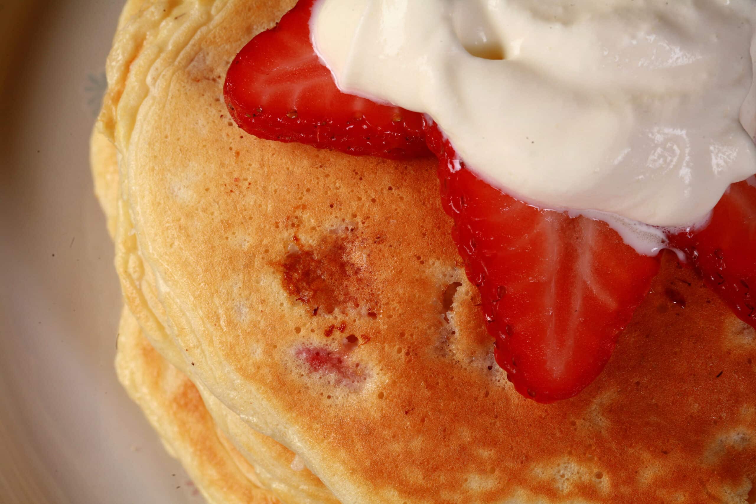 A close up view of the top of a strawberry protein pancake.