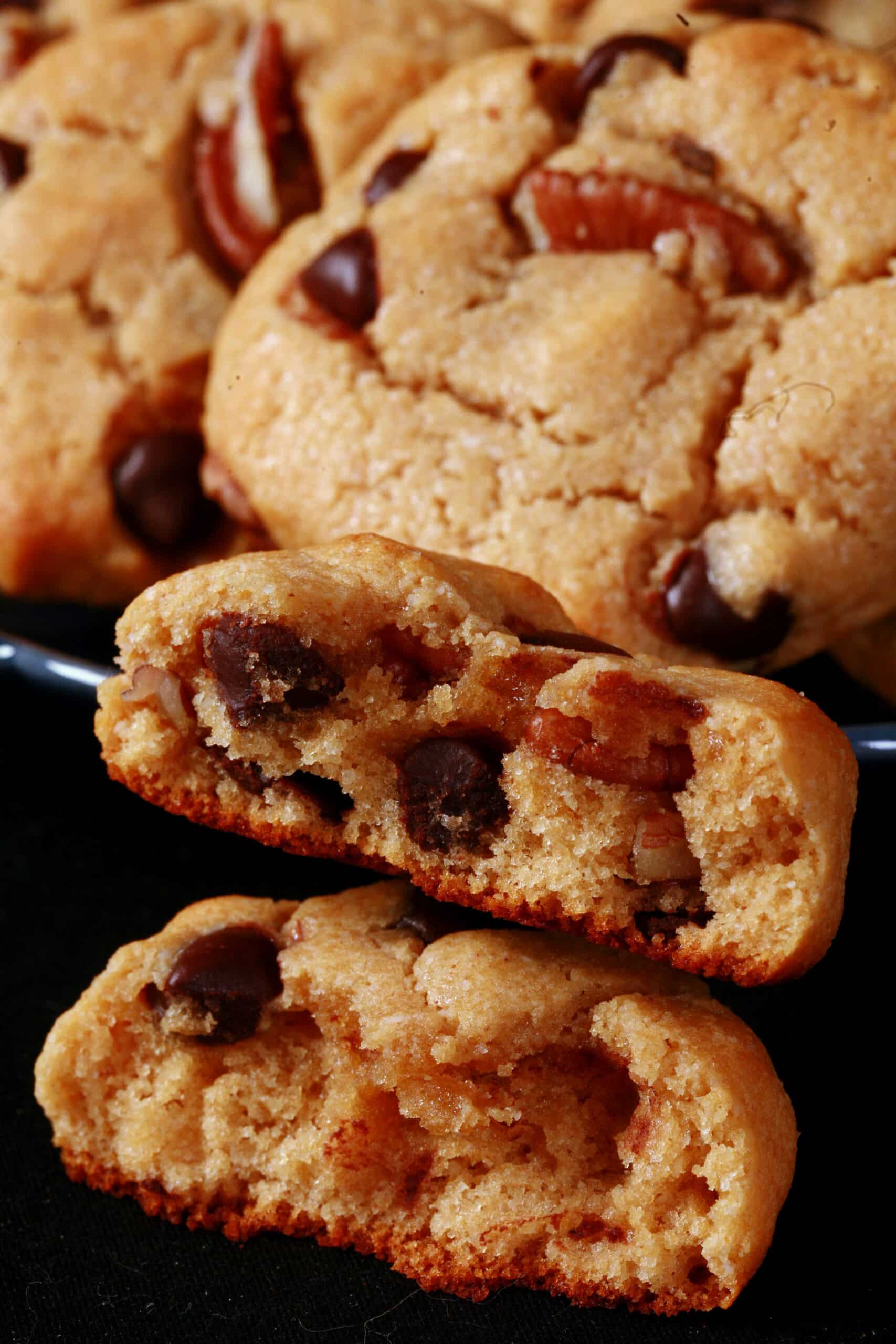 A plate of keto peanut butter cookies with chocolate chips and pecans.