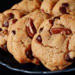 A plate of low carb peanut butter cookies with chocolate chips and pecans.