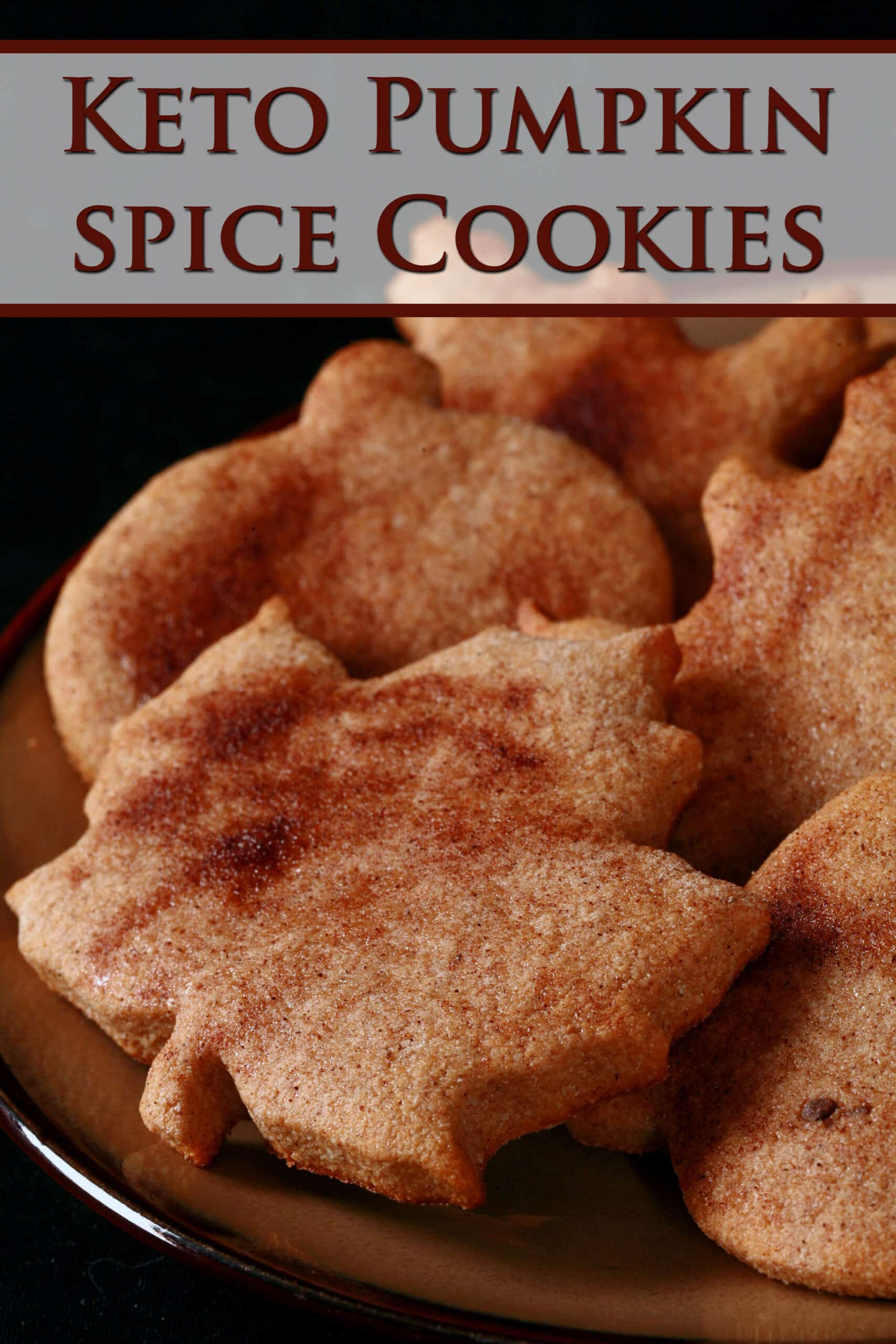 A plate of leaf shaped spiced sugar cookies.  Overlaid text says keto pumpkin spice cookies.