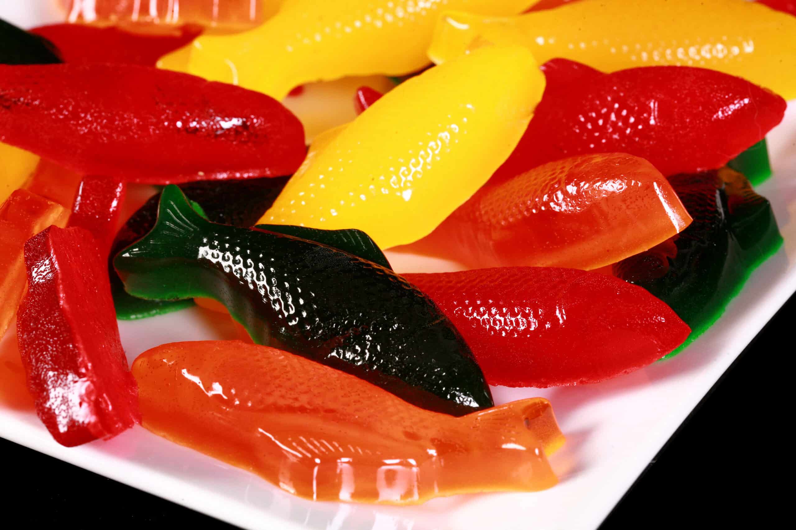 Brightly coloured homemade sugar free swedish fish on a plate.